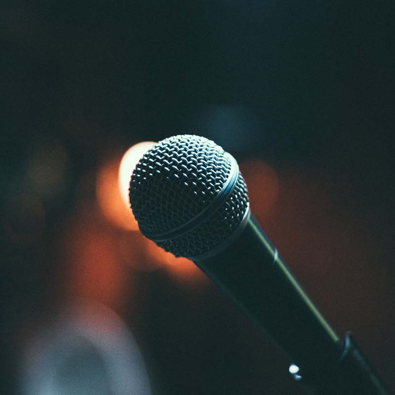 Photo of a microphone against a dark background