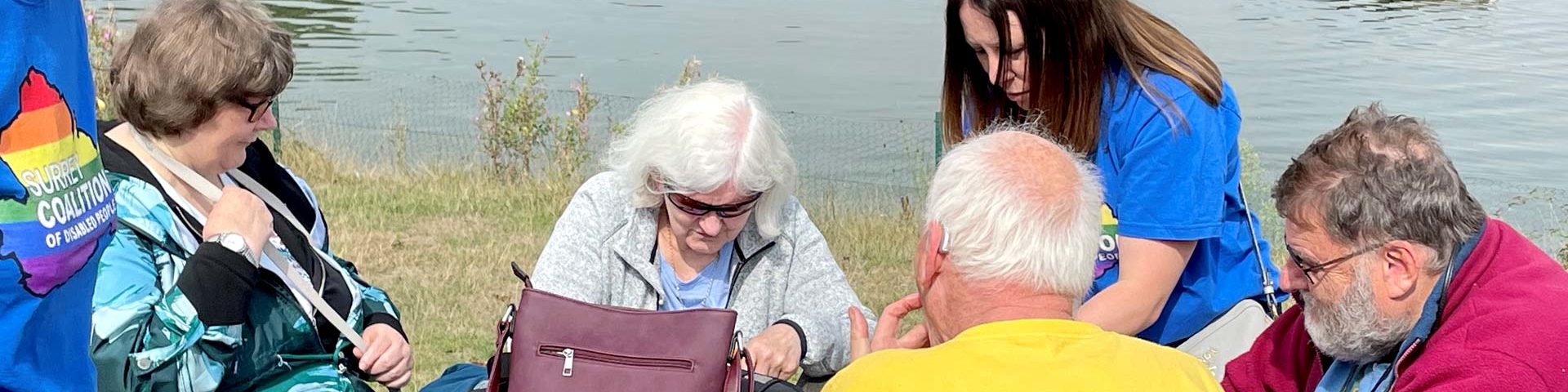 Coalition members and staff sat at a table by a lake