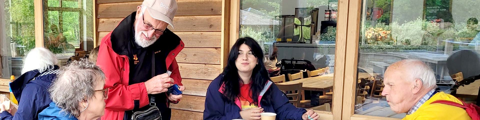 A few of our members and a staff member having a cuppa and cake outside