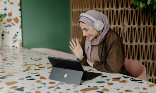 Lady volunteer waving at a tablet