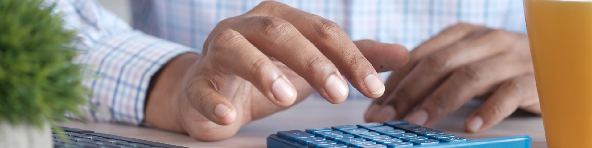 person typing on a calculator