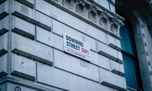 Downing Street Road Sign on the side of a building