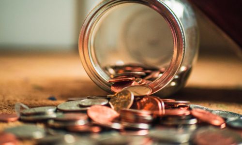 Coins pouring out of a jar