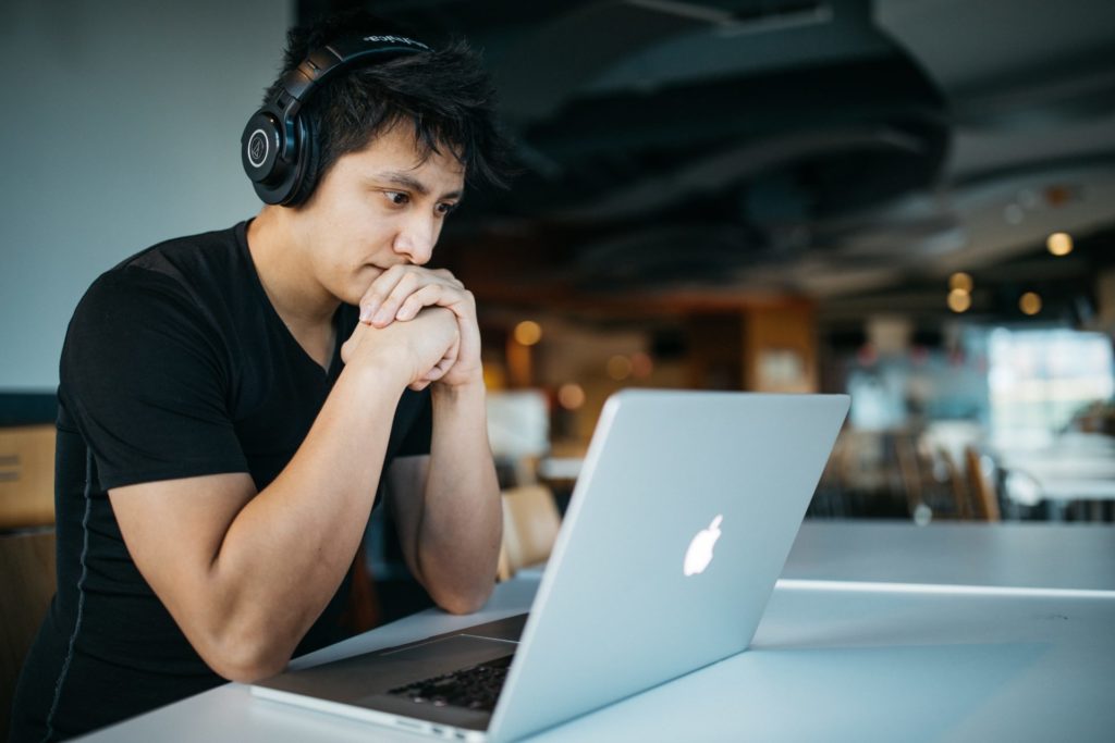 Photo of a man looking at a computer