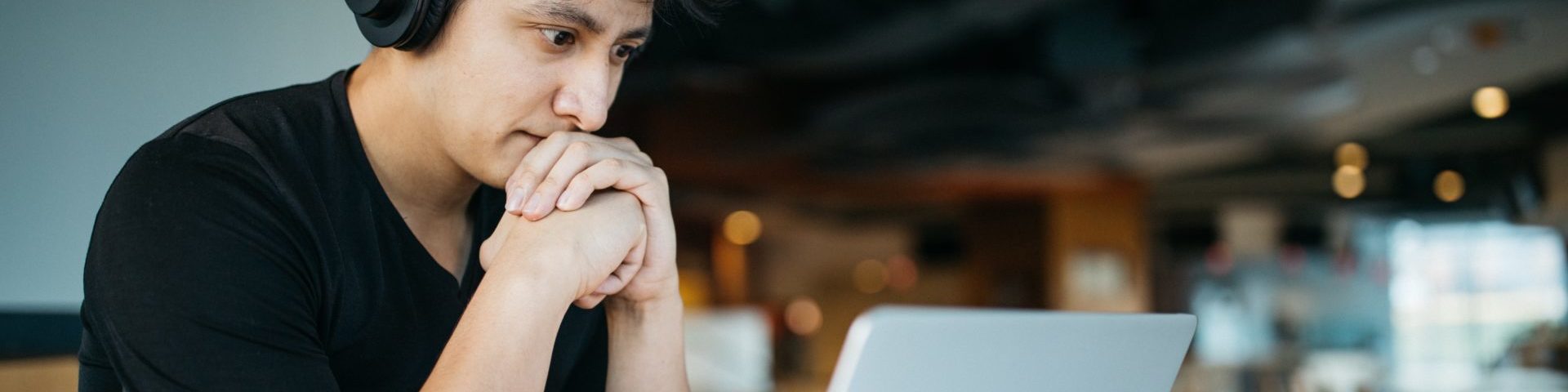 Photo of a man looking at a computer