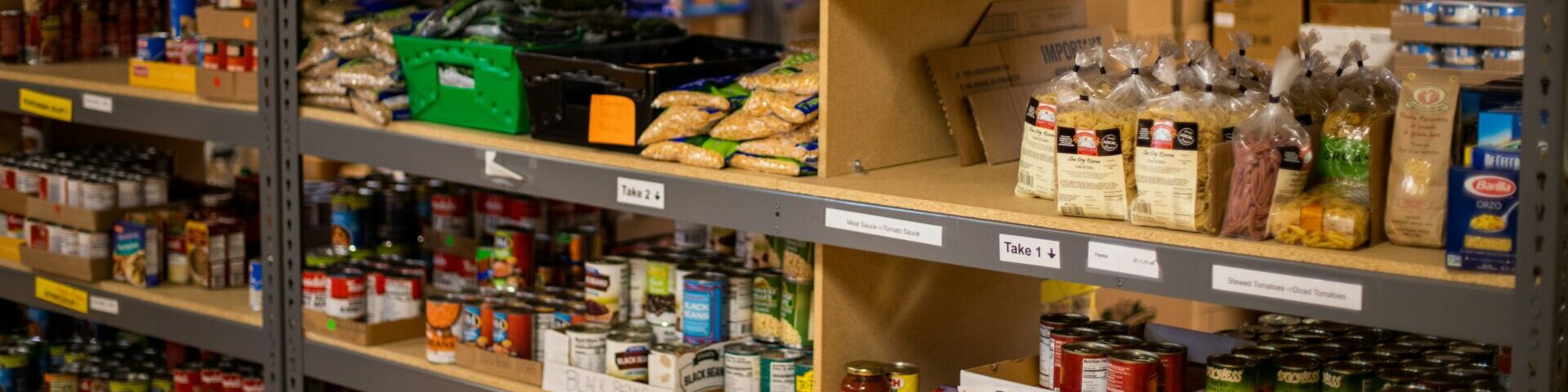 Photo of pasta and tinned food on shelving