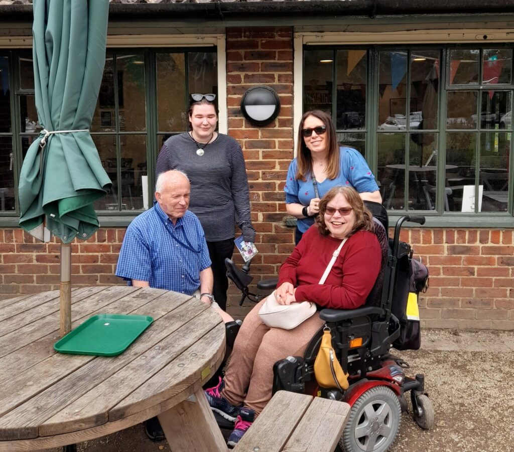 Jonathan, Angie, Yasmin and Alex outside a cafe 