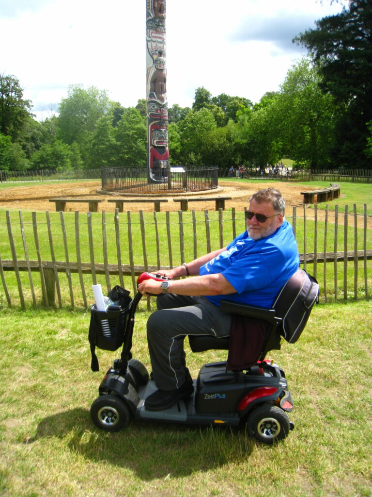 David at Virginia Water with trees in the background and a totem pole