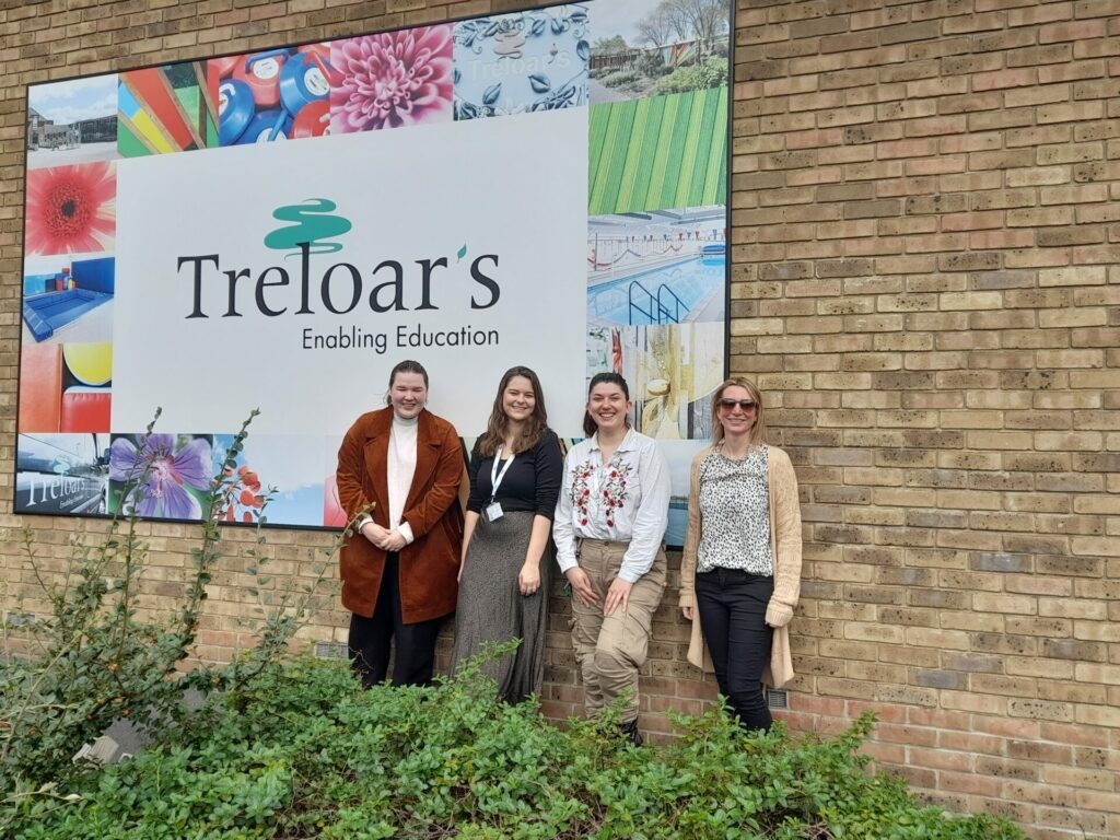 Coalition staff outside Treloar's, with the Treloar's sign behind them.