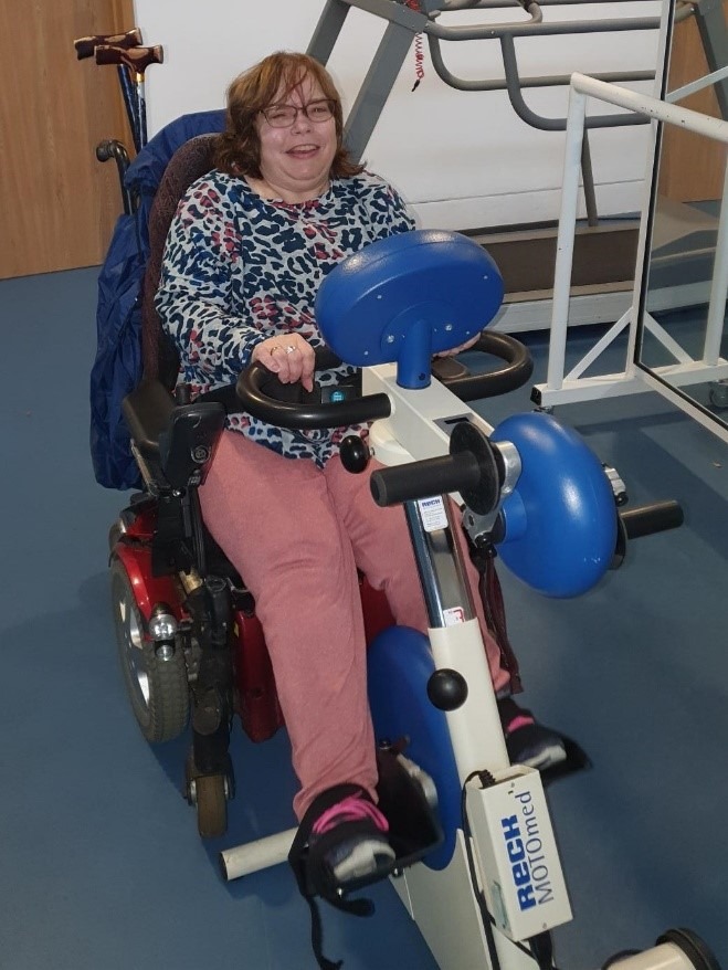 Coalition staff member Angie on a Motomed bike. 