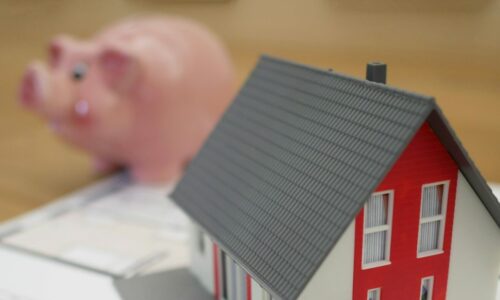 Model house with a money box in the background