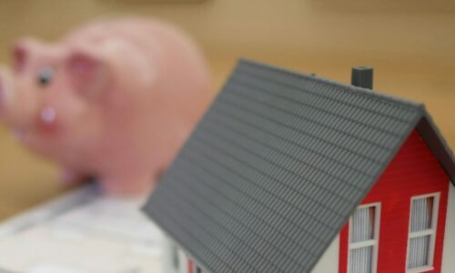 Model house with a money box in the background