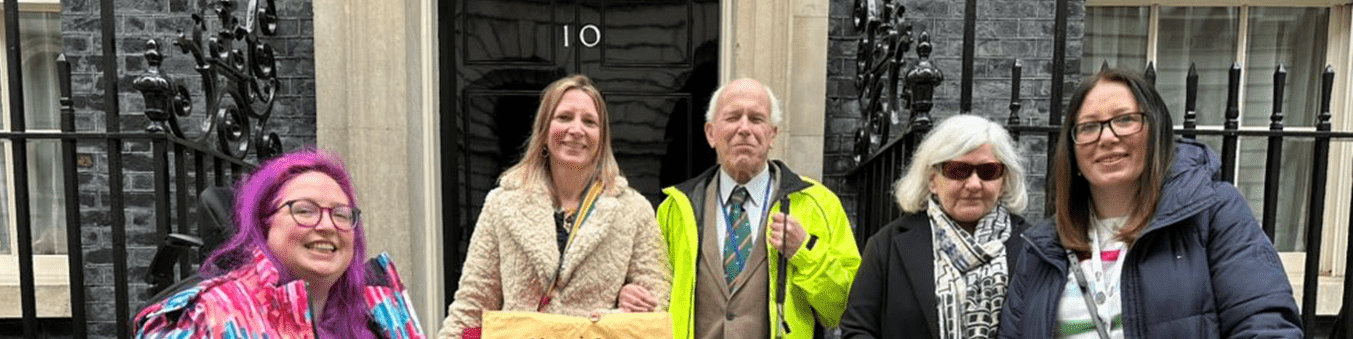 Coalition staff and members in front of the No.10 Downing Street door