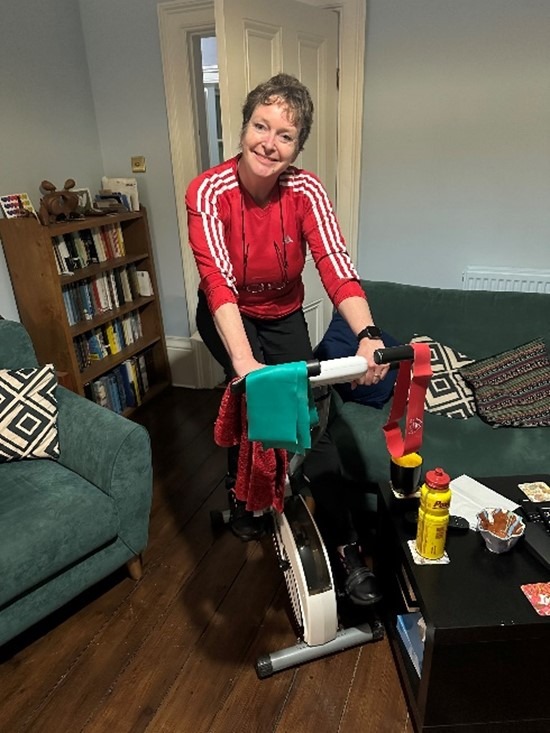 Pam smiling on her exercise bike.