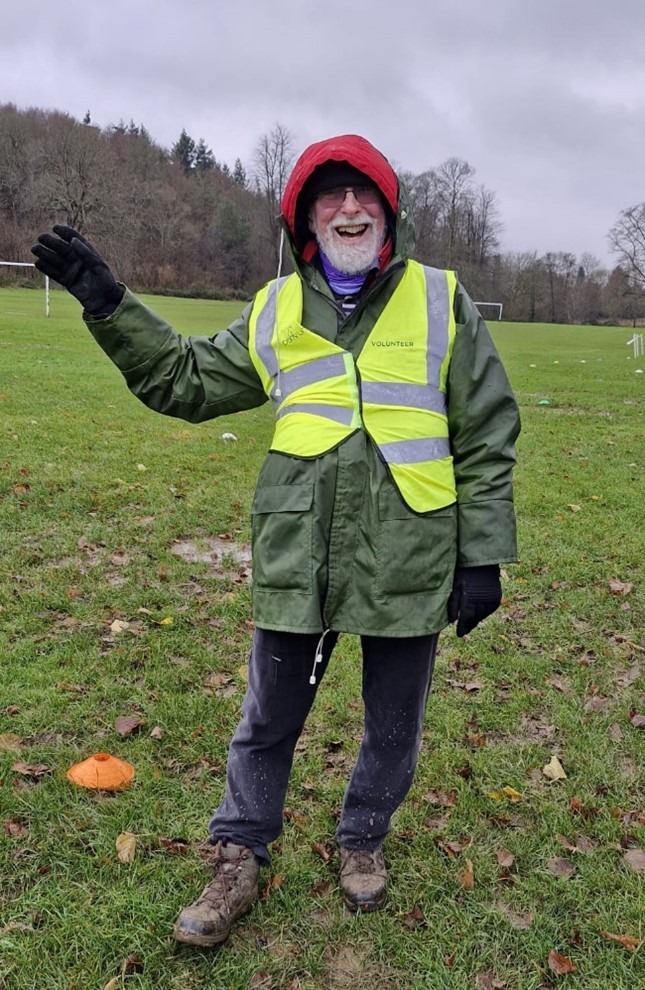 Coalition member Ted waving whilst volunteering at a Park Run event. 