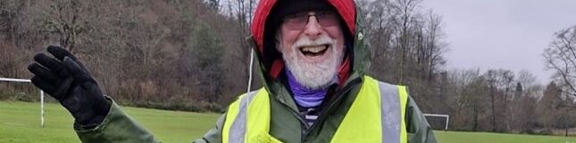 Coalition member Ted waving whilst volunteering at a Park Run event