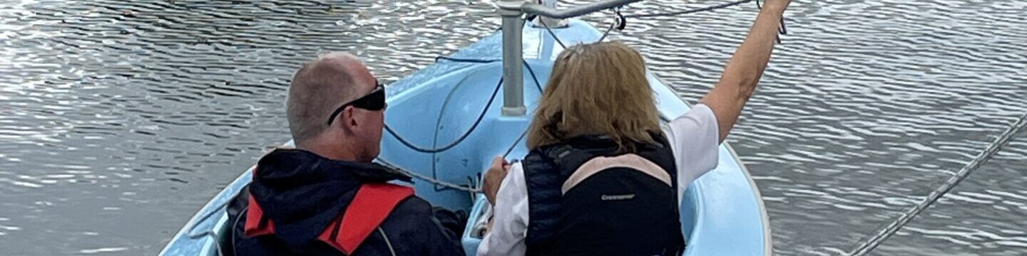 Coalition member in a sailing boat with an instructor at Papercourt sailing lake.