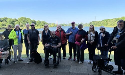 Group photo of Coalition staff and members in front of a lake
