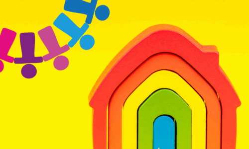 Colourful wooden rainbow house with a yellow background