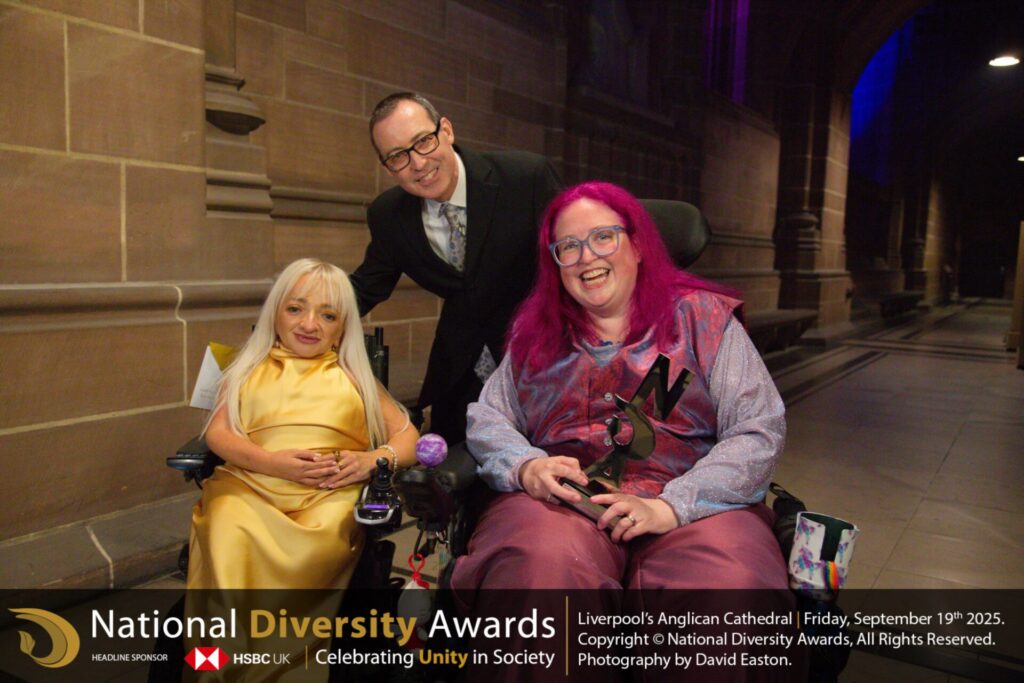 Vikki Walton-Cole, Chair of Trustees at The Coalition holding the award with award presenters Tom Jamison and Samantha Renke. 