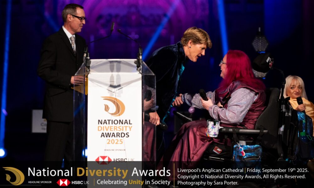 Vikki Walton-Cole, Chair of Trustees at The Coalition receiving the award from Tom Jamison, Samantha Renke and Clare Balding at the National Diversity Awards.