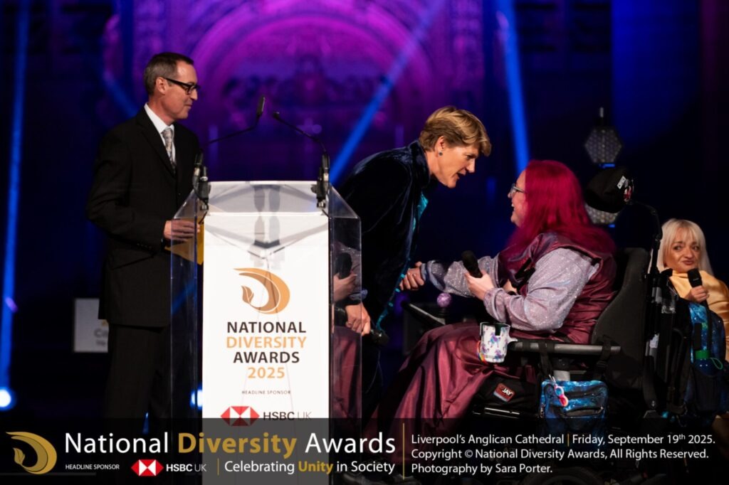 Vikki Walton-Cole, Chair of Trustees at The Coalition receiving the award from Tom Jamison, Samantha Renke and Clare Balding at the National Diversity Awards. 
