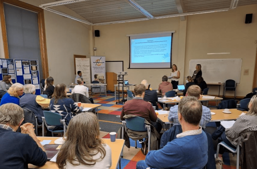 Nikki and Rachel presenting to a room of people at the Surrey Museums Partnership meeting