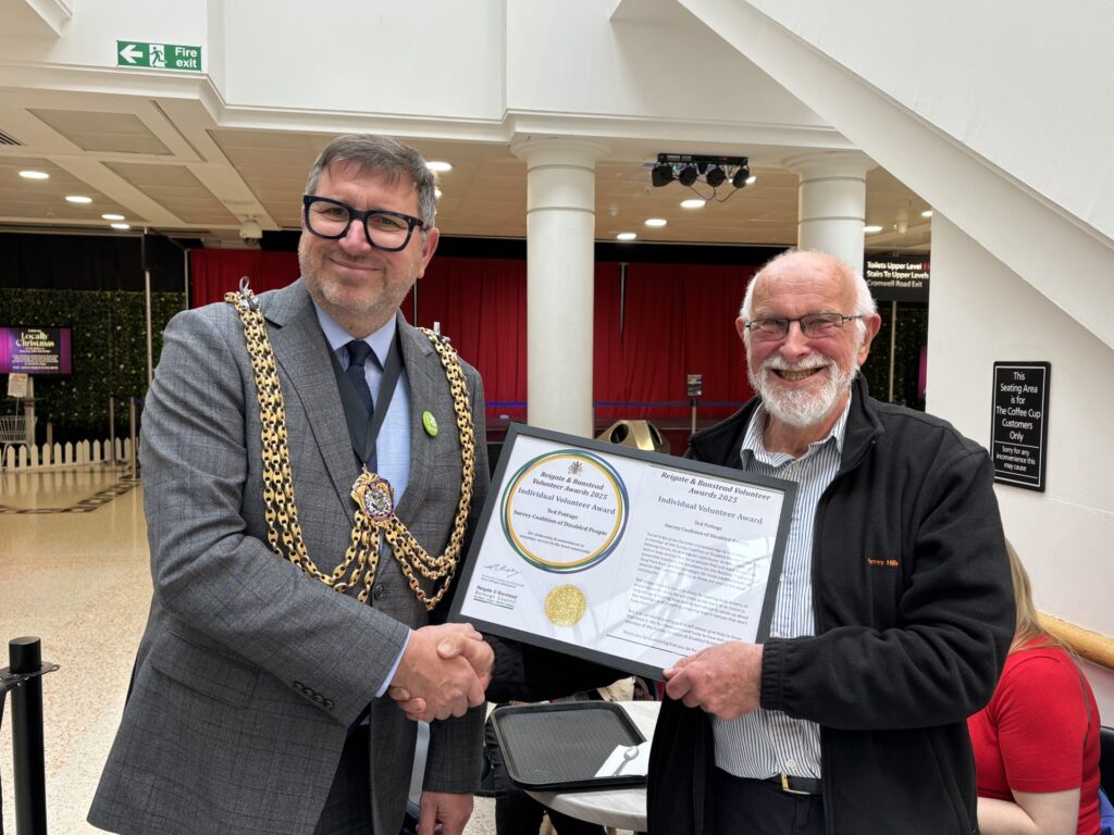 The Mayor of Reigate & Banstead shaking hands Ted and presenting him with the Volunteers awards. 