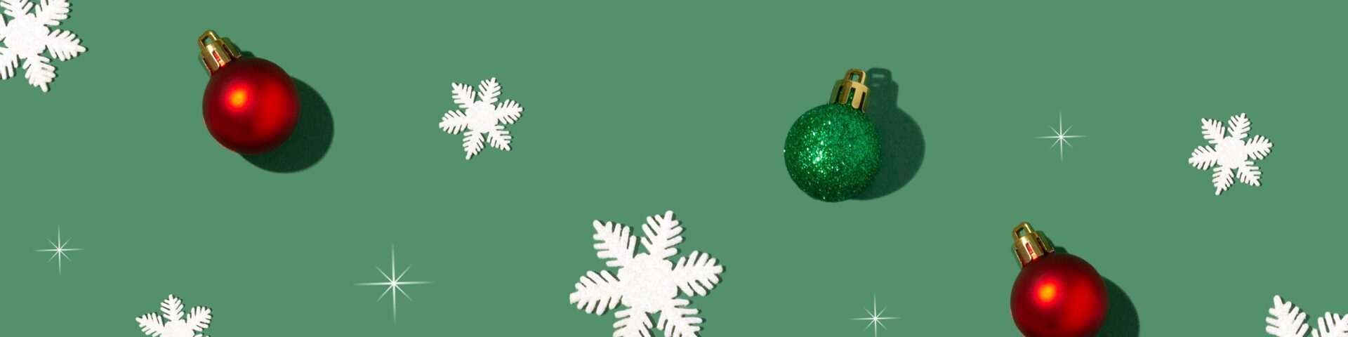 Green background with snowflakes and red and green baubles.