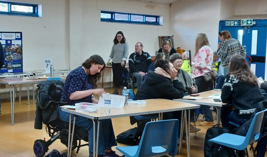 Coalition members and staff around tables doing a craft activity