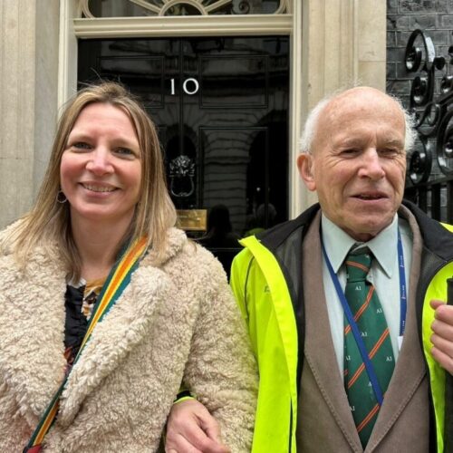 CEO Nikki with Coalition member Jonathan in front of Number 10 Downing street door.