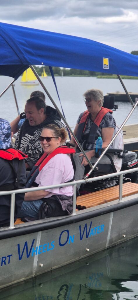 Coalition members smiling on a boat