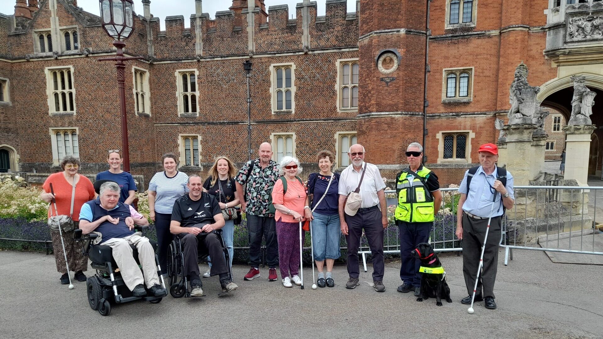 Group photo of Coalition members and staff outside Hampton Court Palace. 