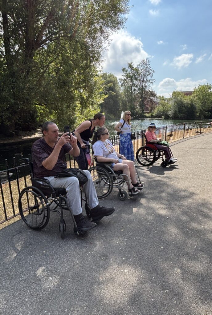 Coalition members and staff by a river on a sunny day