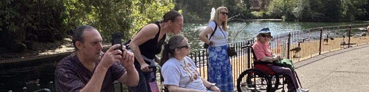 Coalition members and staff by a river on a sunny day