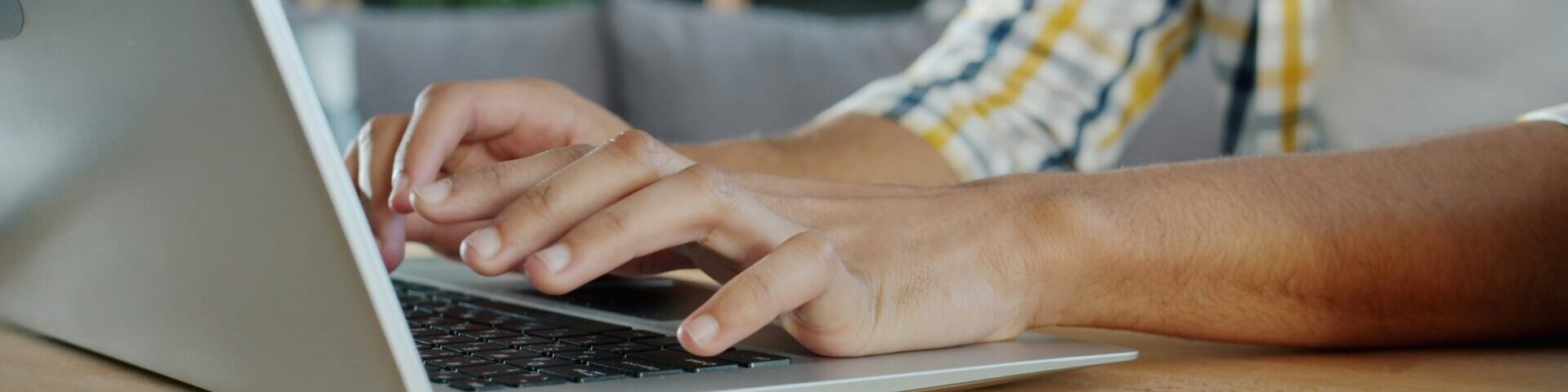 Person typing on laptop.
